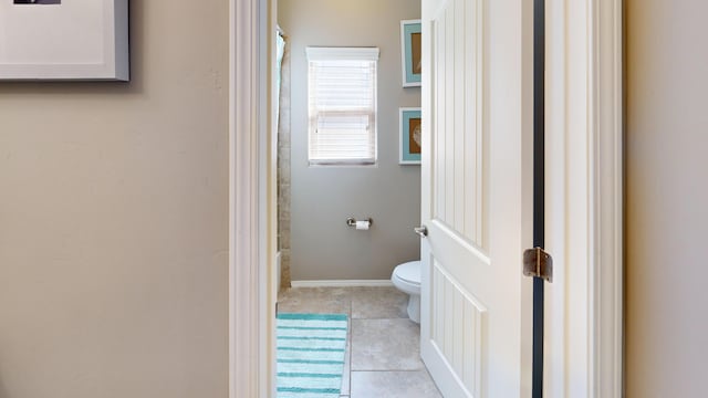 bathroom featuring tile patterned flooring and toilet