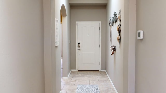 doorway with light tile patterned floors