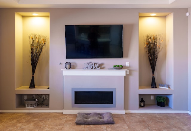 living room with a fireplace, built in shelves, and light tile patterned flooring