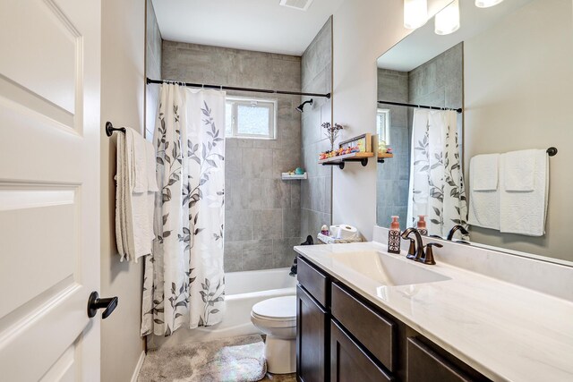 full bathroom with vanity, toilet, and shower / tub combo