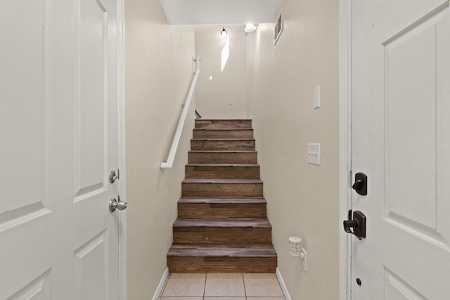 staircase with tile patterned flooring