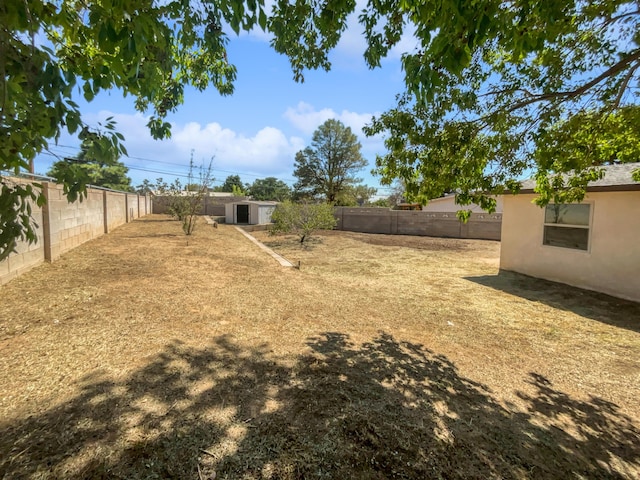 view of yard with an outbuilding and a fenced backyard