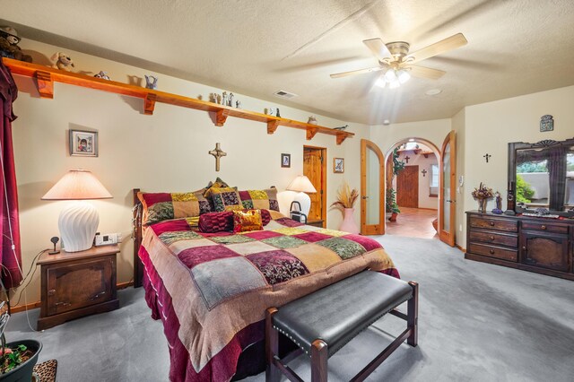 bedroom with a textured ceiling, ceiling fan, and carpet