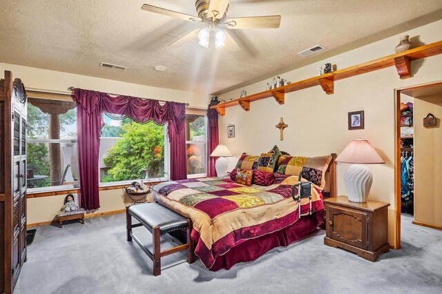 bedroom featuring ceiling fan, light carpet, and multiple windows