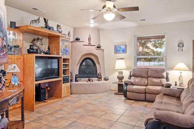 living room featuring ceiling fan and light tile patterned flooring