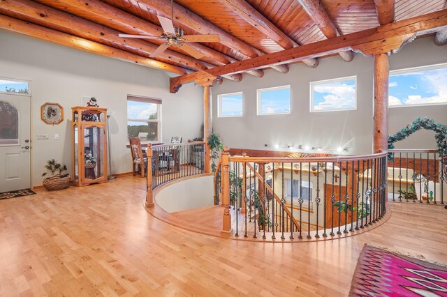 miscellaneous room with wooden ceiling, beam ceiling, light hardwood / wood-style flooring, and ceiling fan