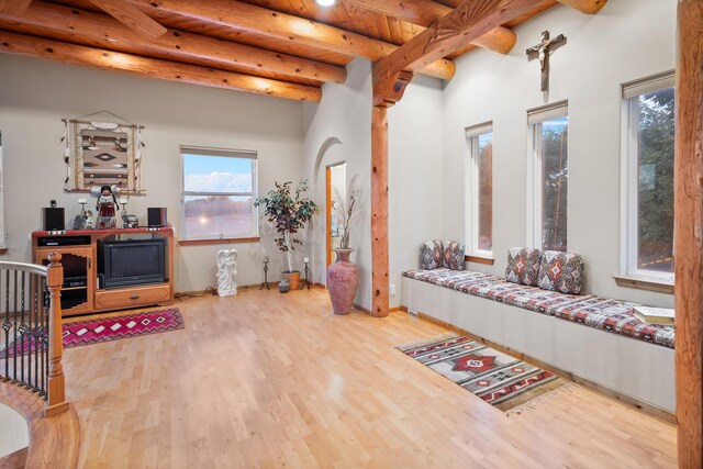 living room featuring wood ceiling, light hardwood / wood-style floors, and beamed ceiling