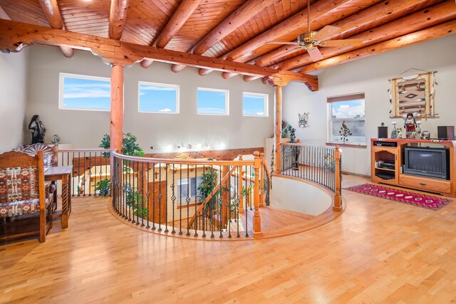 interior space featuring wood ceiling, ceiling fan, light hardwood / wood-style floors, and beamed ceiling