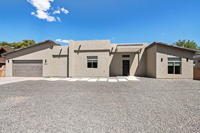 view of front of property with an attached garage and stucco siding