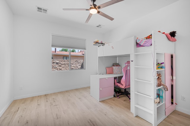 bedroom with light wood finished floors, baseboards, visible vents, and a ceiling fan