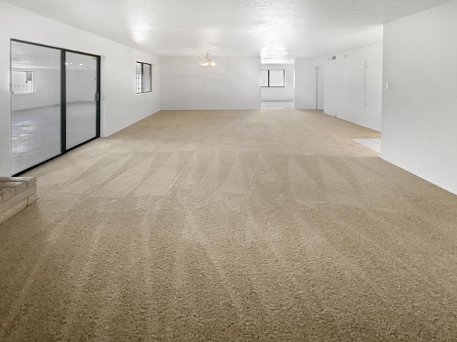 carpeted spare room with a healthy amount of sunlight