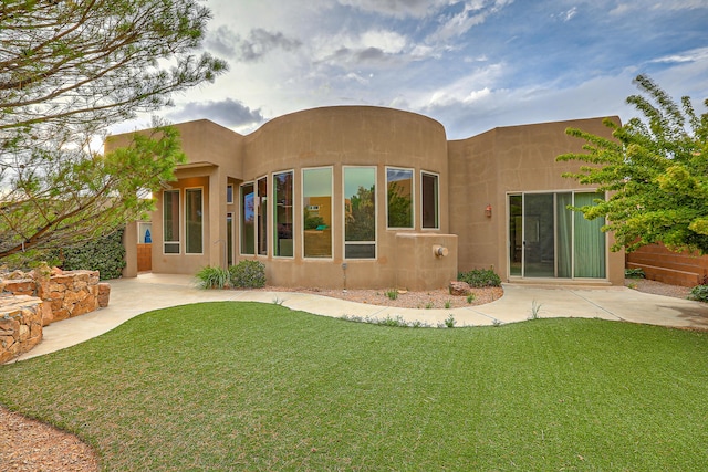 back of house featuring a yard and a patio area