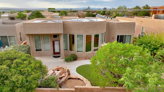 back of house with stucco siding