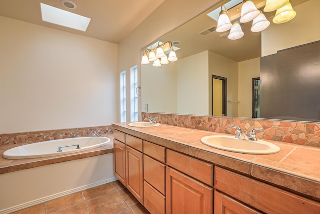 full bath featuring a sink, visible vents, a skylight, and tile patterned flooring