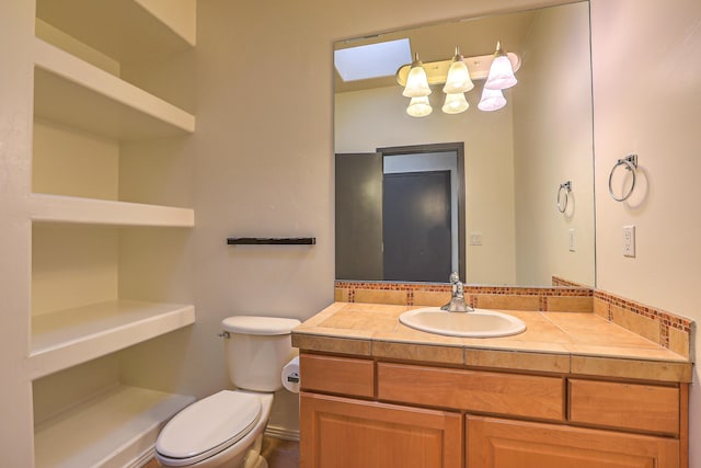 bathroom with toilet and vanity