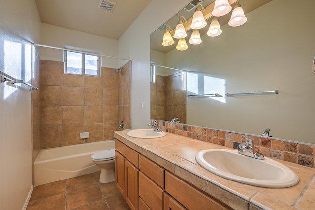 bathroom featuring a sink, visible vents, bathtub / shower combination, and tile patterned flooring