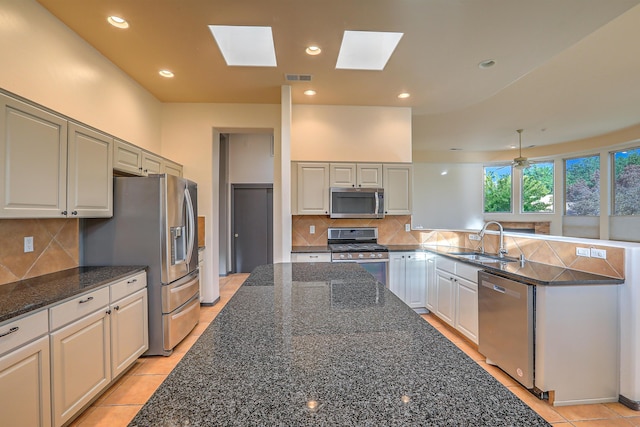 kitchen featuring visible vents, a sink, recessed lighting, appliances with stainless steel finishes, and a peninsula