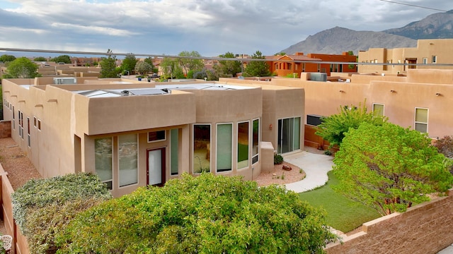 back of property featuring stucco siding and a mountain view