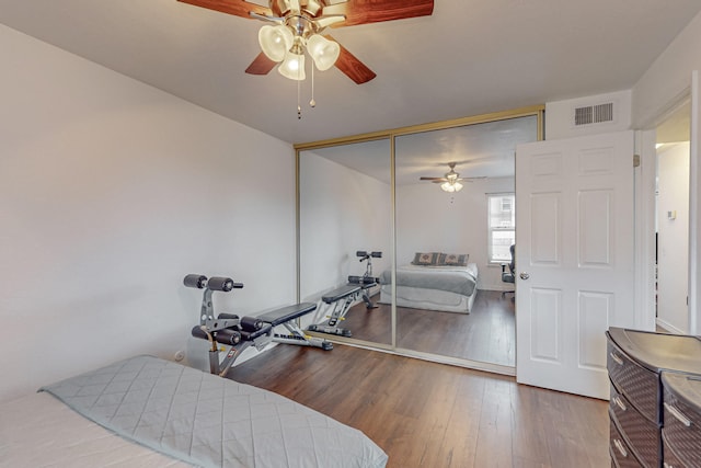 bedroom with a closet, ceiling fan, and hardwood / wood-style floors