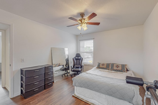 bedroom featuring hardwood / wood-style flooring and ceiling fan