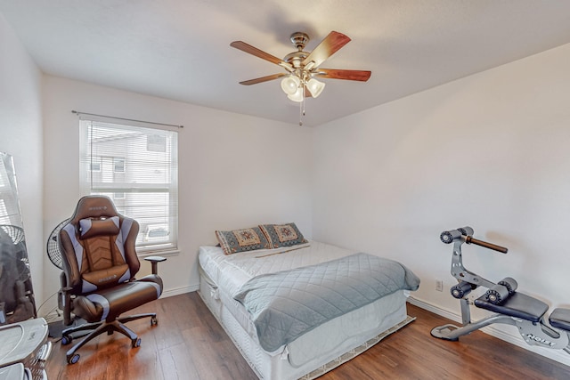 bedroom with ceiling fan and hardwood / wood-style flooring