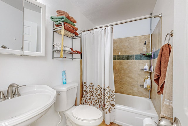 full bathroom featuring toilet, sink, and shower / bath combination with curtain