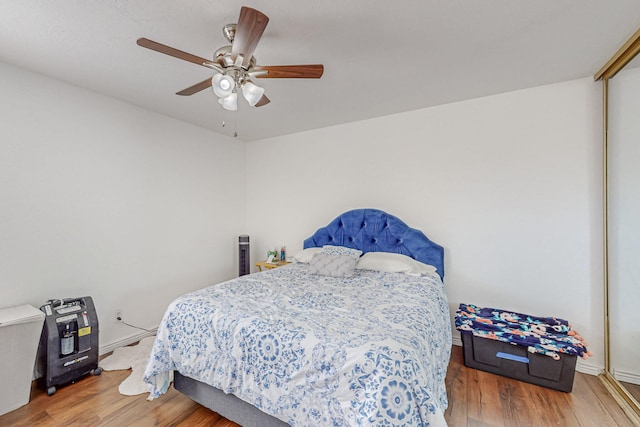 bedroom with hardwood / wood-style floors and ceiling fan