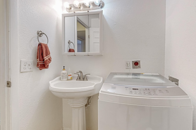 bathroom with washer / dryer and sink