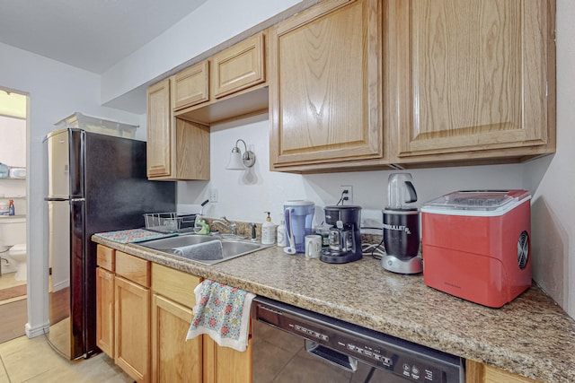 kitchen with light tile patterned floors, light brown cabinets, sink, and stainless steel dishwasher