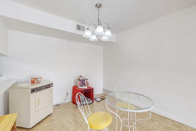 interior space with washer / dryer, a chandelier, and light tile patterned flooring