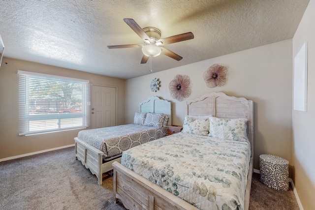 carpeted bedroom featuring ceiling fan and a textured ceiling