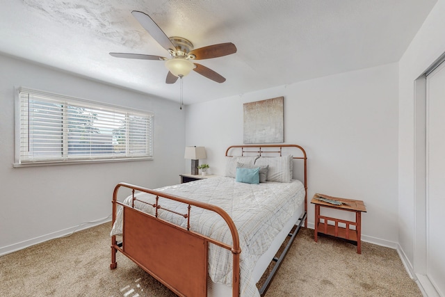 bedroom featuring light carpet and ceiling fan