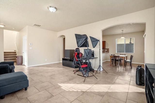 living room featuring light tile patterned floors and a textured ceiling