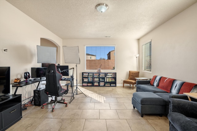 living room with light tile patterned floors and a textured ceiling