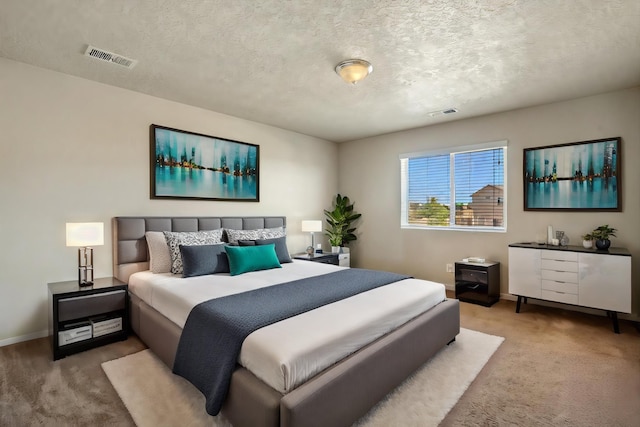 carpeted bedroom with a textured ceiling