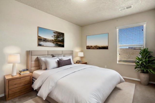 carpeted bedroom featuring a textured ceiling