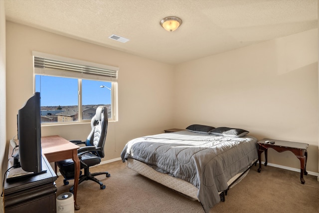 bedroom with carpet and a textured ceiling