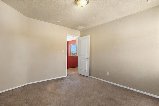 carpeted spare room featuring a textured ceiling