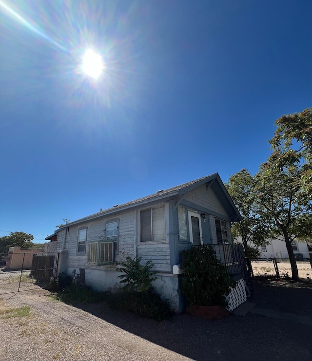 view of side of home with central AC unit