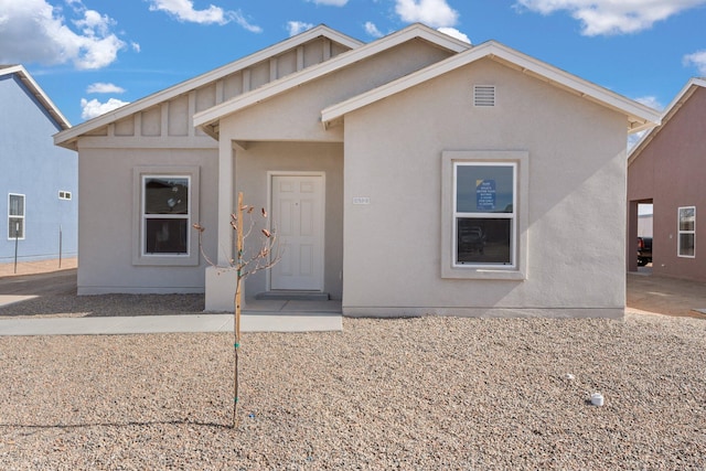 view of front facade with board and batten siding and stucco siding