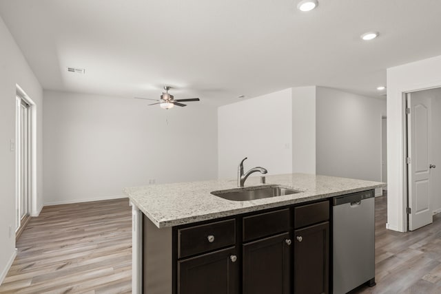 kitchen with light hardwood / wood-style flooring, a center island with sink, sink, ceiling fan, and stainless steel dishwasher