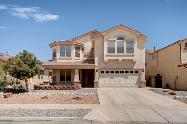 mediterranean / spanish-style house with covered porch and a garage