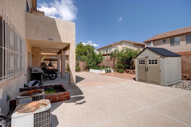 view of patio / terrace featuring a storage shed and cooling unit