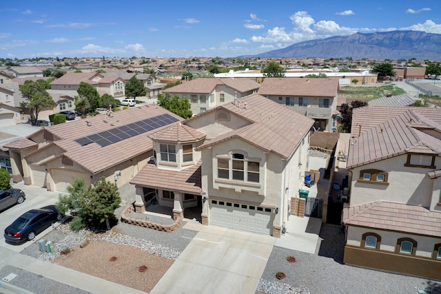 view of front facade with a mountain view and a garage