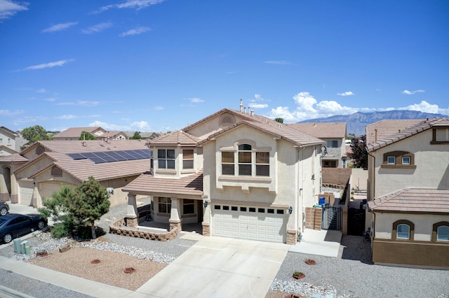 view of front facade featuring a mountain view and a garage