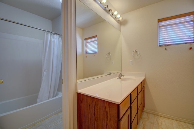 bathroom featuring shower / bath combo and vanity