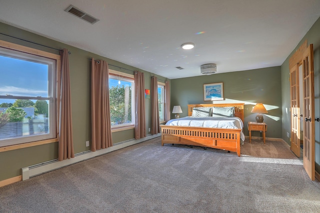 carpeted bedroom featuring baseboards, visible vents, and baseboard heating