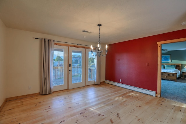 unfurnished dining area with a chandelier, a baseboard radiator, visible vents, and light wood finished floors