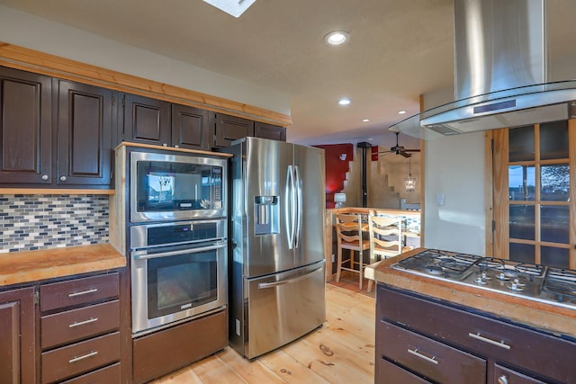 kitchen with extractor fan, recessed lighting, stainless steel appliances, light wood-type flooring, and tasteful backsplash