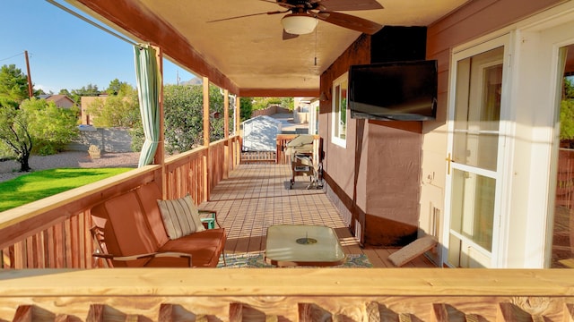 wooden deck featuring ceiling fan